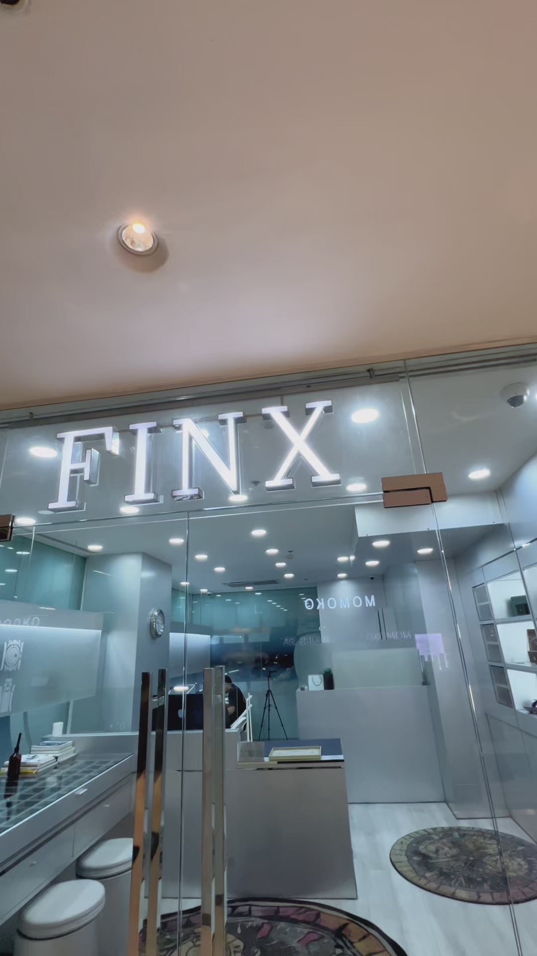 Load video: Interior of a FINX watch protection store with professional film installation and luxury watch service setting